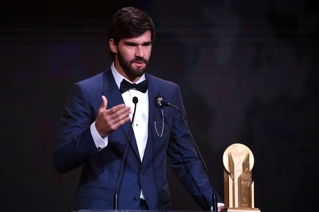 image of Alisson Becker receiving the first ever (Lev) Yashin Award for best goalkeeper in the world.